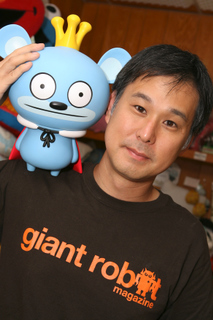 Eric Nakamura poses with Bossy Bear, one of the novelties popularized by the Giant Robot stores.